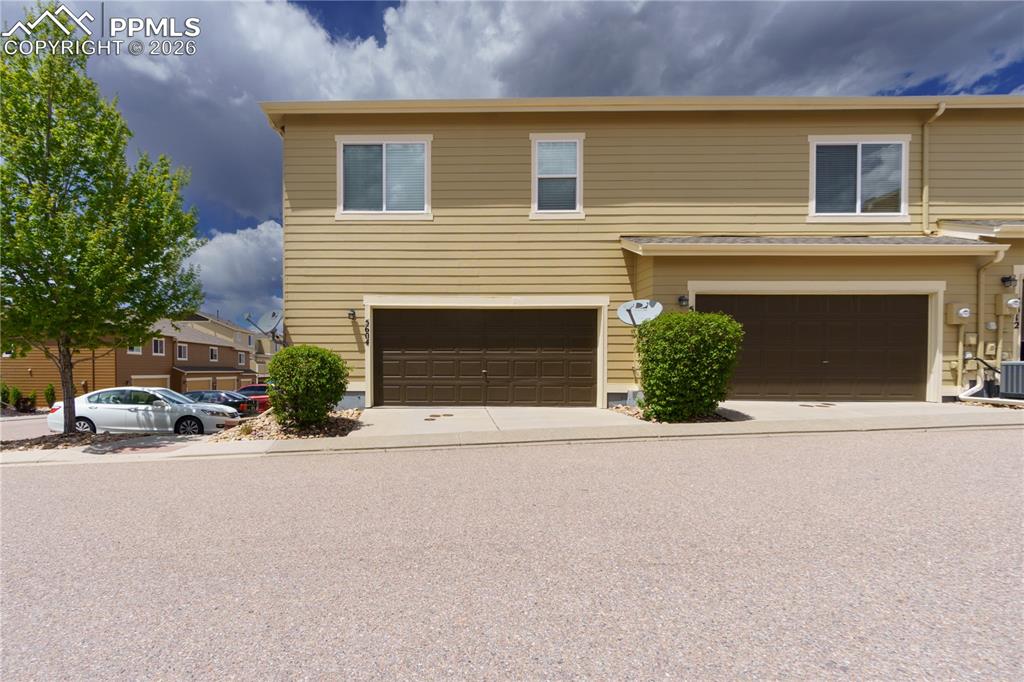 Traditional-style home with a garage and concrete driveway