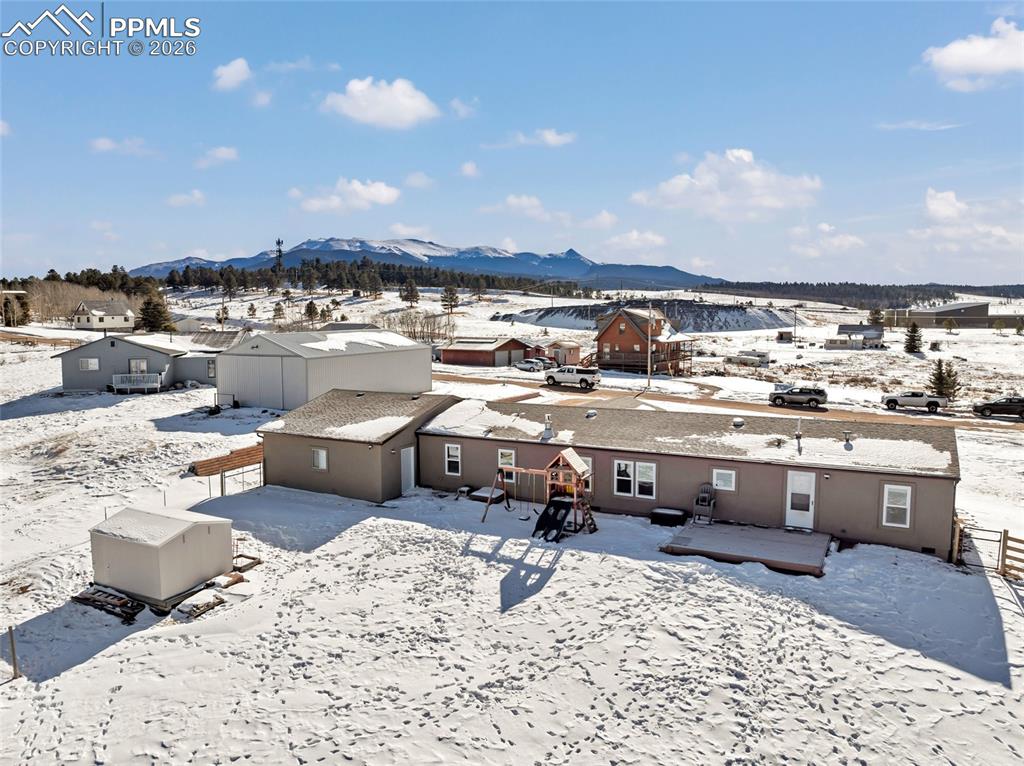 Snowy aerial view featuring a mountain view
