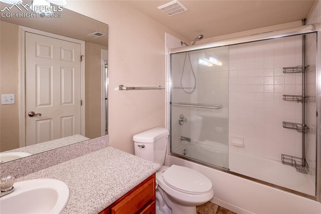 Full bathroom featuring enclosed tub / shower combo and vanity
