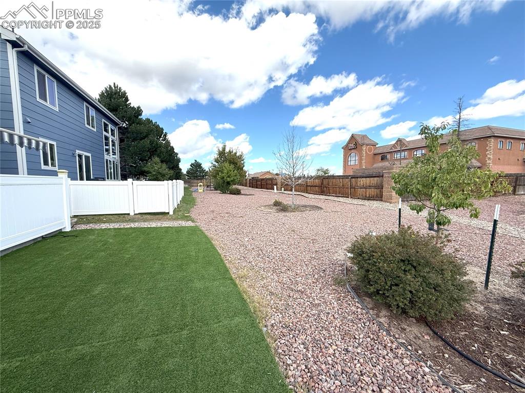 Fenced backyard with a residential view