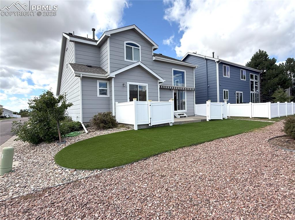 Rear view of house featuring a wooden deck