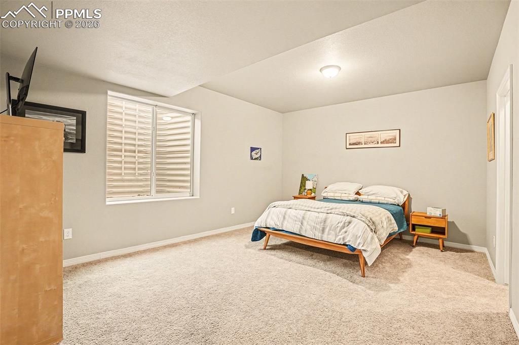 Bedroom featuring carpet floors and baseboards