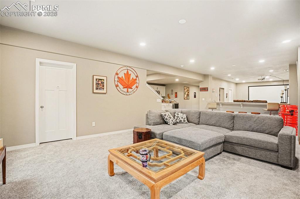 Carpeted living area featuring recessed lighting