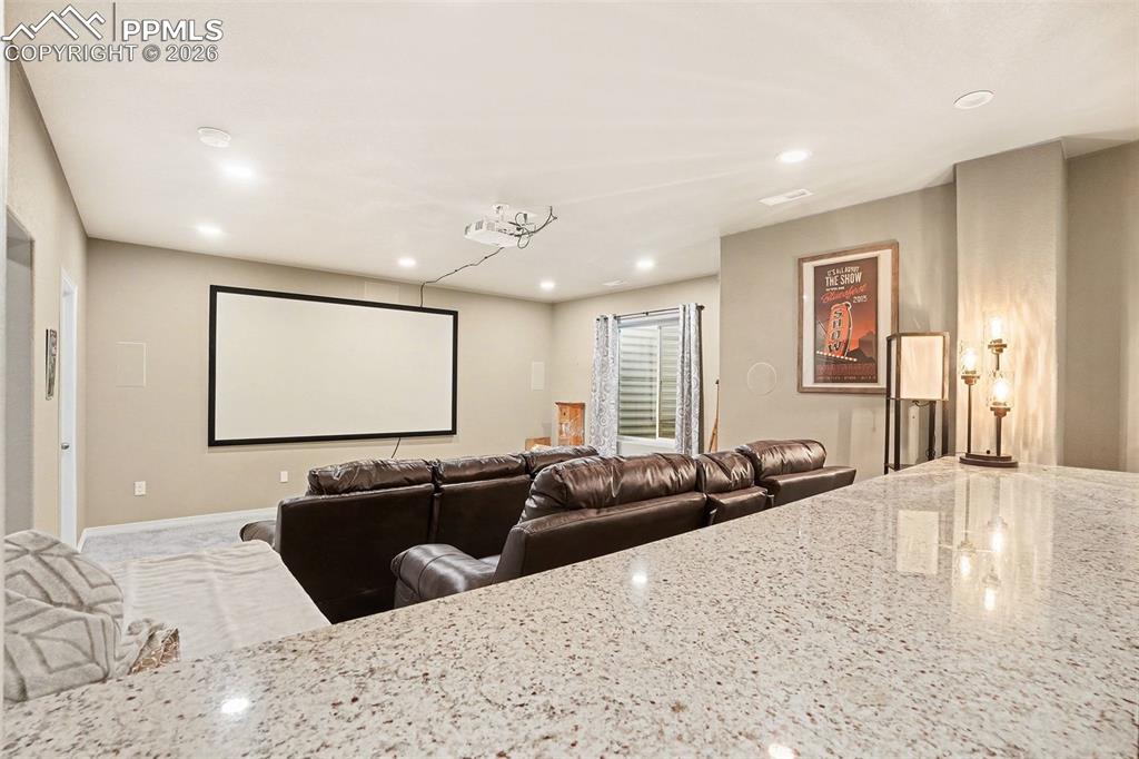 Cinema with recessed lighting and baseboards