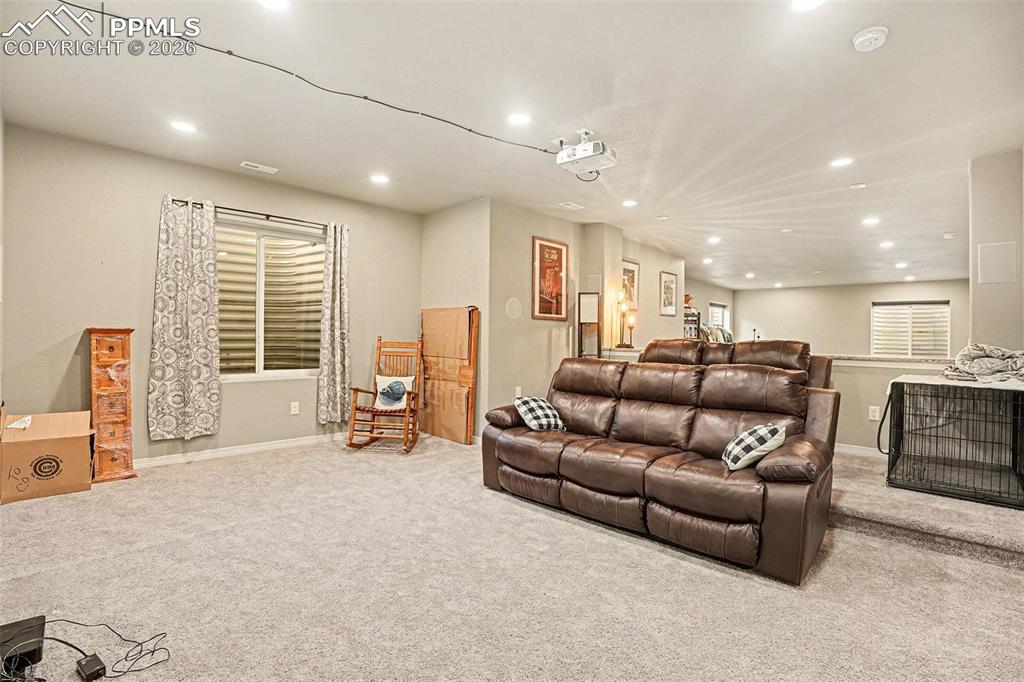Carpeted living room with recessed lighting
