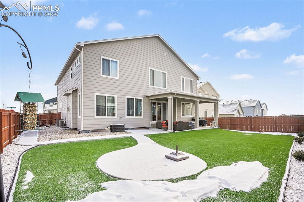Rear view of house featuring a patio area and a fenced backyard