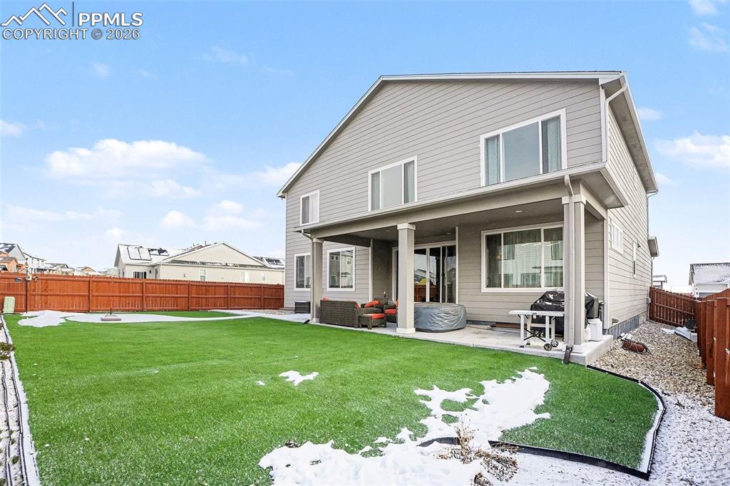 Back of property with a patio and a fenced backyard