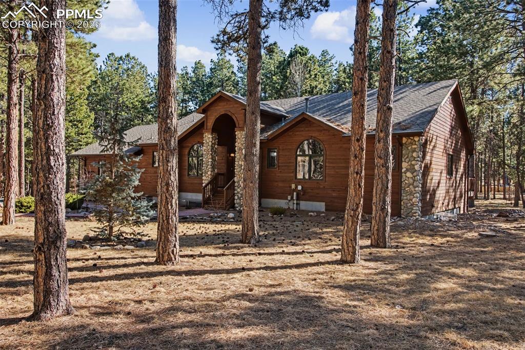 View of front of home featuring roof with shingles