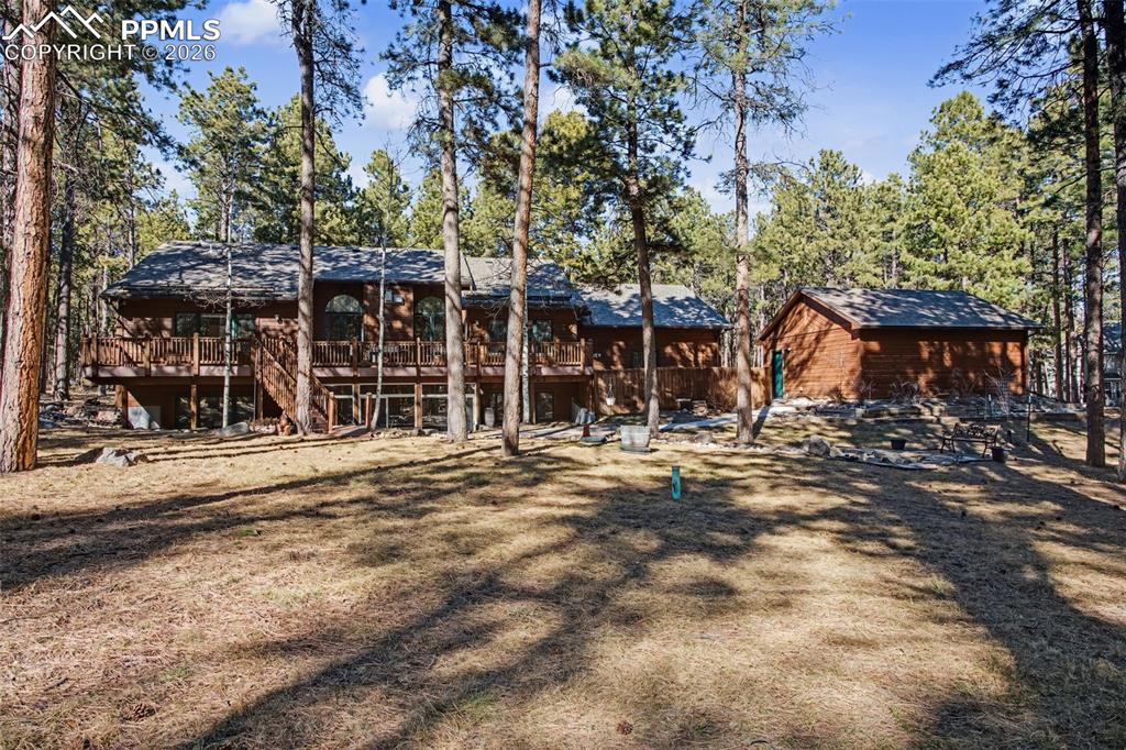 View of front of property with a deck and stairway