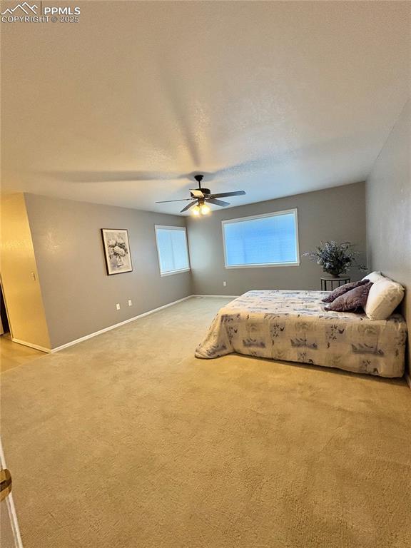 Bedroom featuring light carpet and ceiling fan