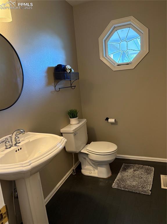 Bathroom featuring toilet and baseboards