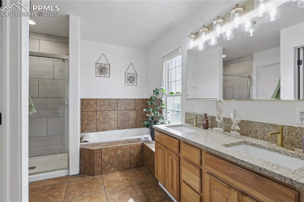 Main-level primary suite offers a peaceful retreat with a luxurious 5-piece ensuite bath and walk-in closet.