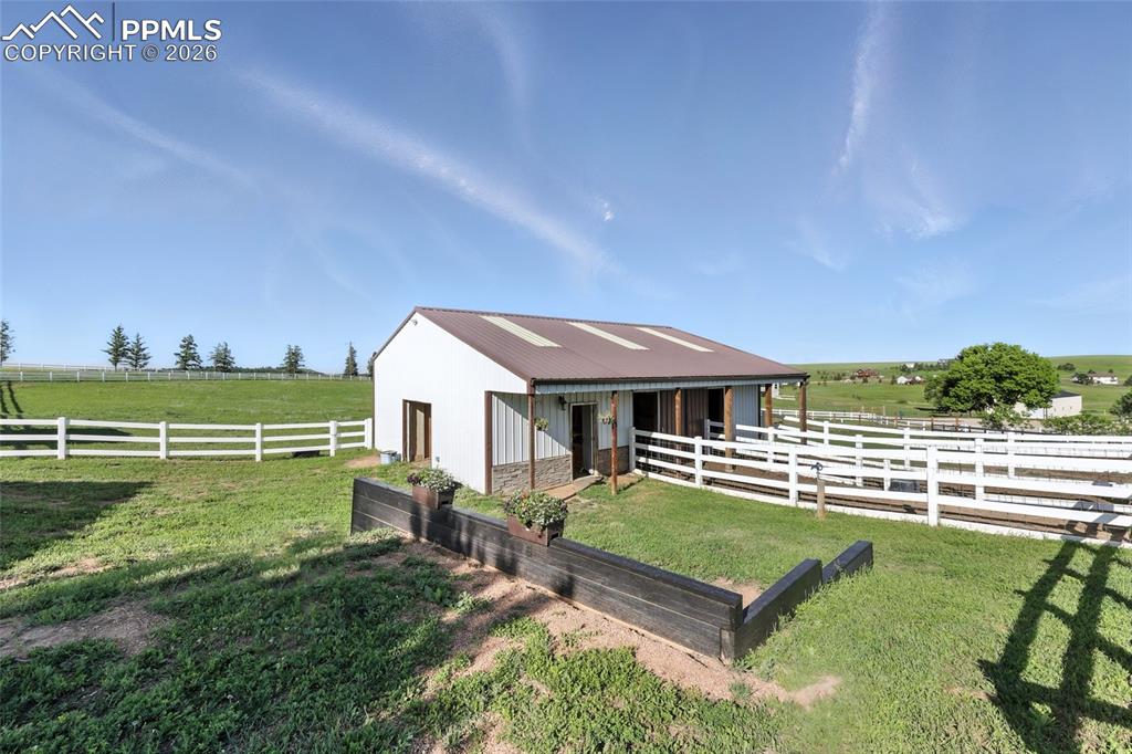 30x40 barn is fully equipped with two Priefert horse stalls, water and electric, a tack room, workshop, horse paddocks, and fenced pastures. 30amp RV hookups on barn with easy access to water hookups.