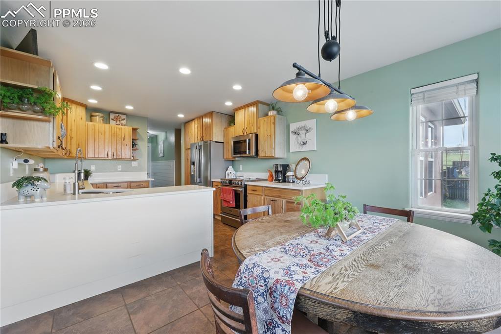Kitchen features hickory cabinets, new quartz countertops, stainless steel appliances, and a breakfast nook with walkout access to a large deck. 