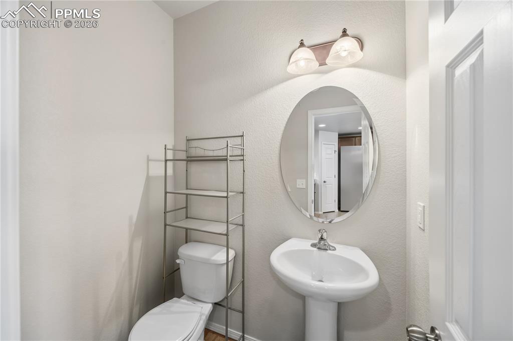 Convenient Powder Bathroom with pedestal sink.