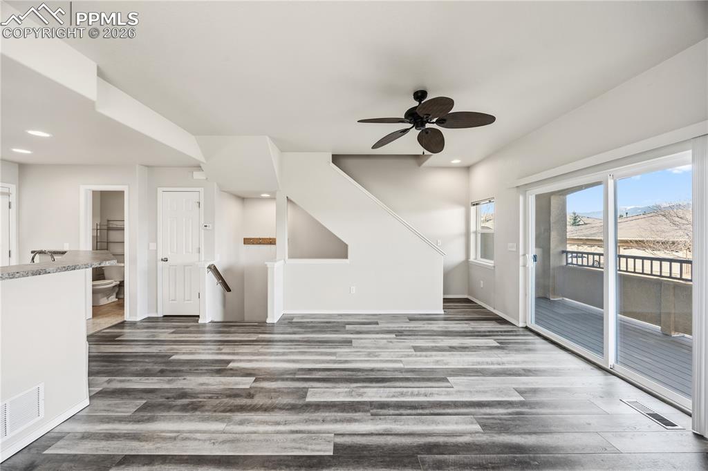 Living Room with stairs to the upper level and basement.