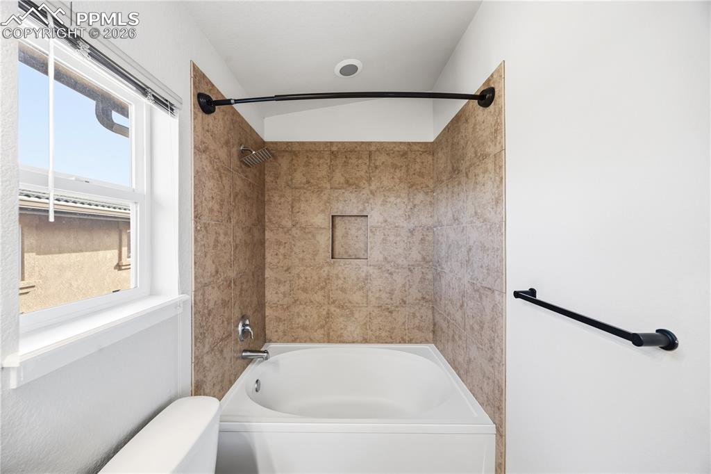 Tiled tub/shower in the Primary Bathroom.