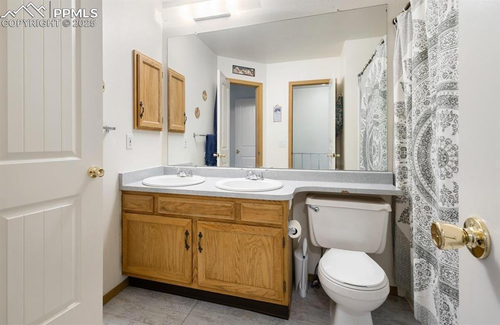 Bathroom with a shower with shower curtain and double vanity