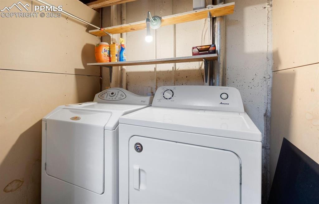Laundry room featuring washer and clothes dryer