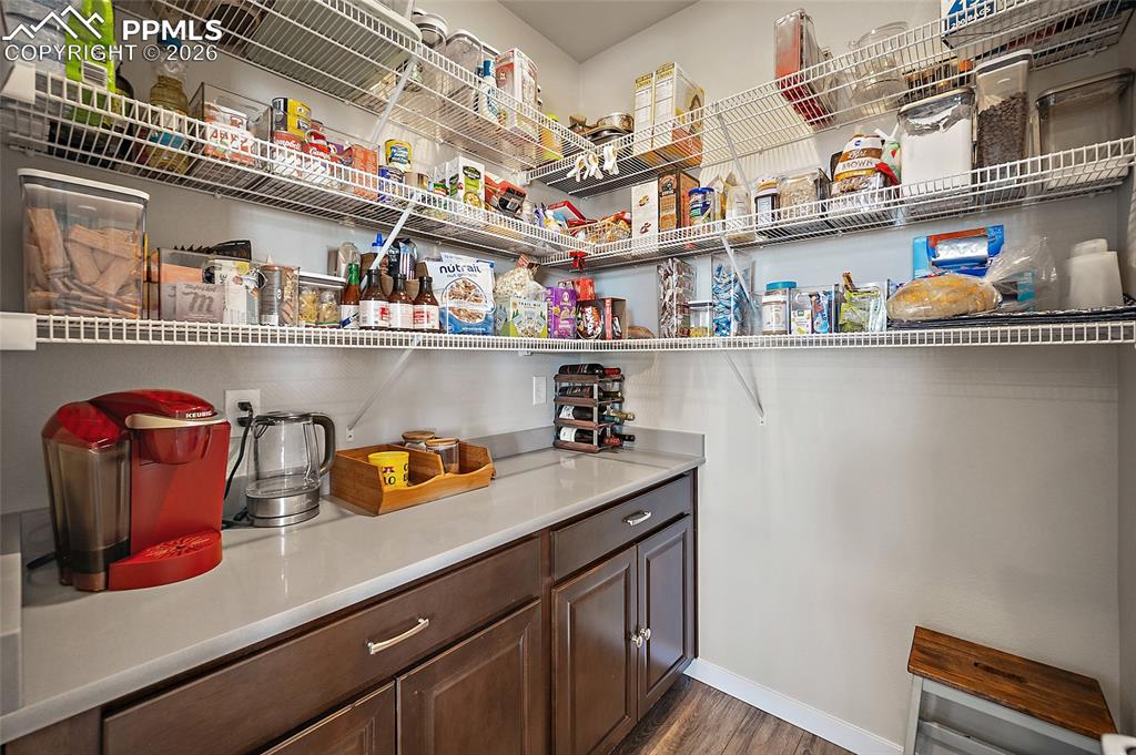 Buttler's pantry with generous counter space, cabinets and overhead shelving
