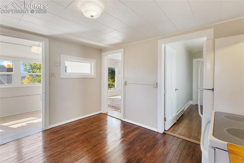 Entrance foyer featuring hardwood / wood-style floors and a baseboard radiator