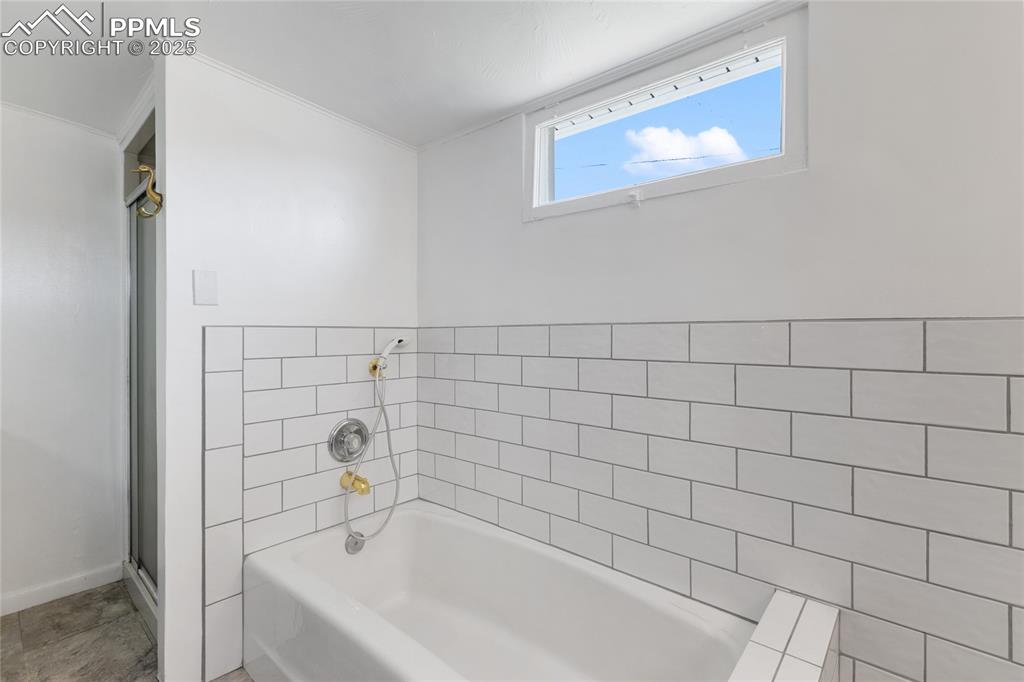 Bathroom with a bath and a shower stall