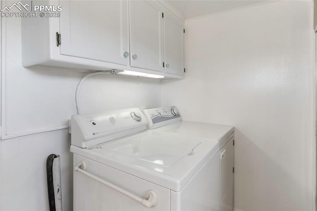 Laundry room with cabinet space and separate washer and dryer
