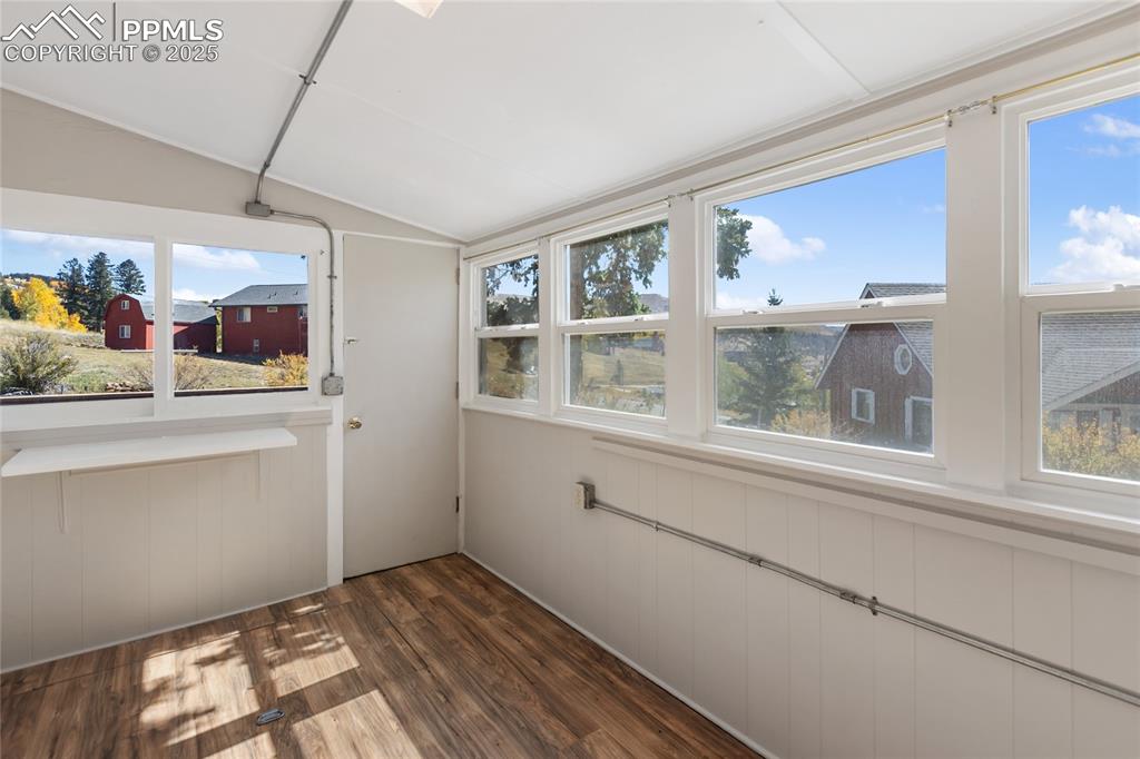 Unfurnished sunroom with lofted ceiling