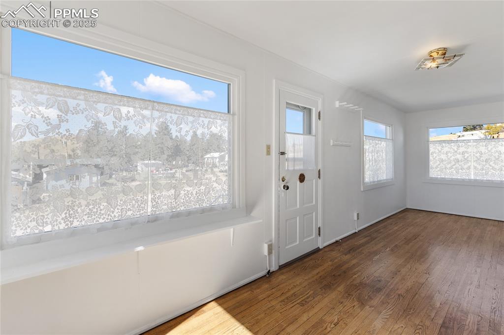 Entrance foyer with dark wood-type flooring and baseboards