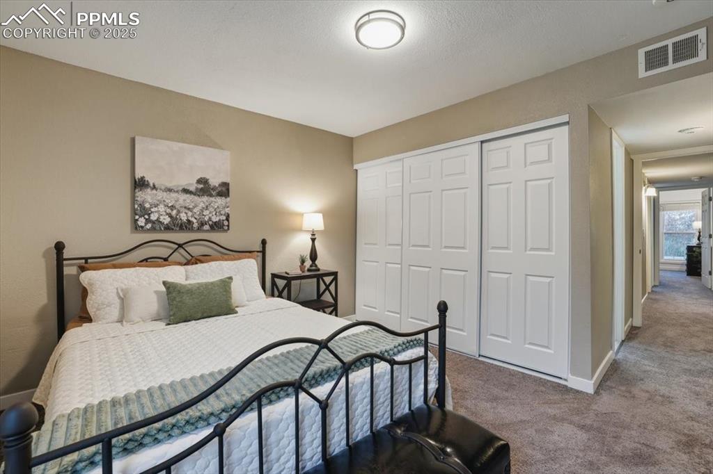 Bedroom with carpet and a closet