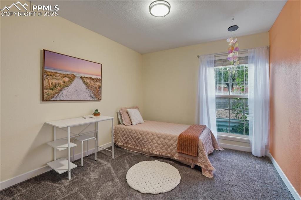 Bedroom featuring carpet floors and a textured ceiling