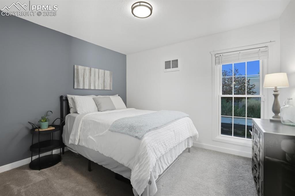 Bedroom featuring light carpet