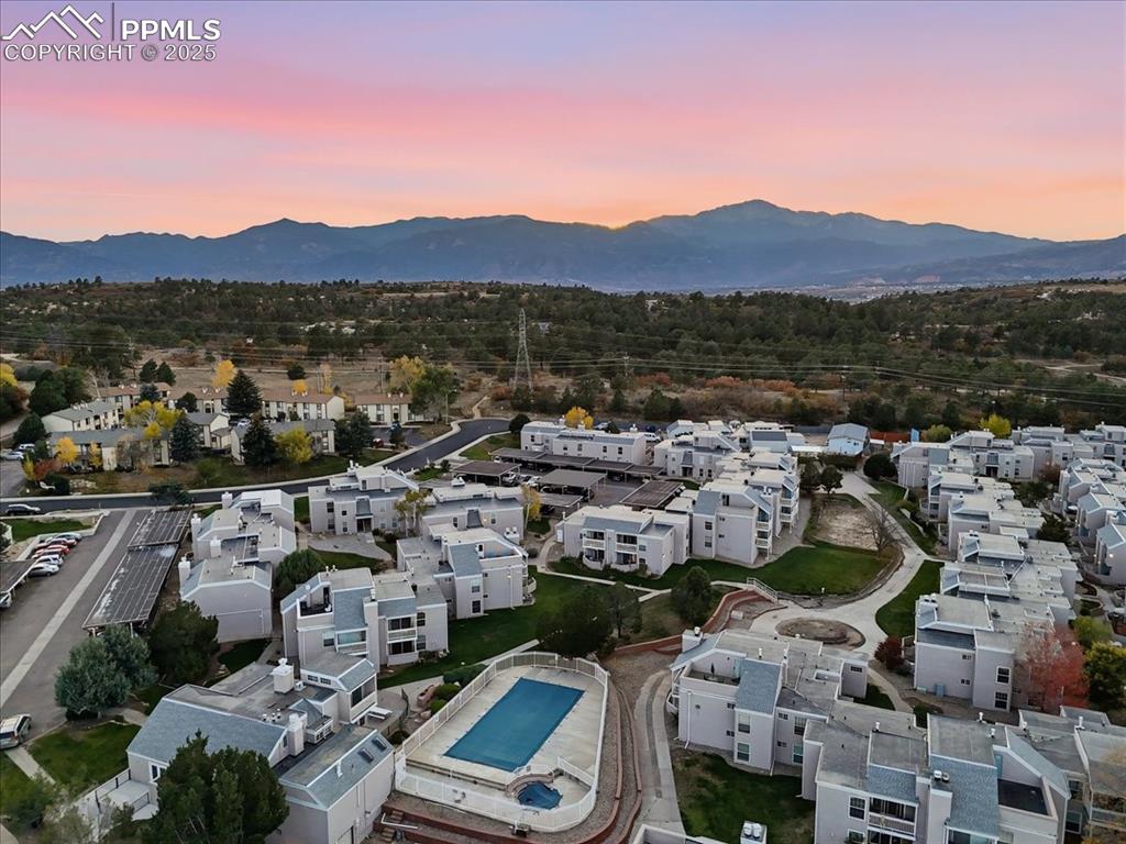 Aerial overview of property's location with nearby suburban area and mountains