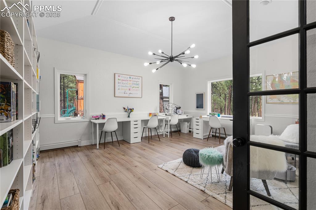 The main level office is adjacent to the living room and features built ins and a 2 sided fireplace