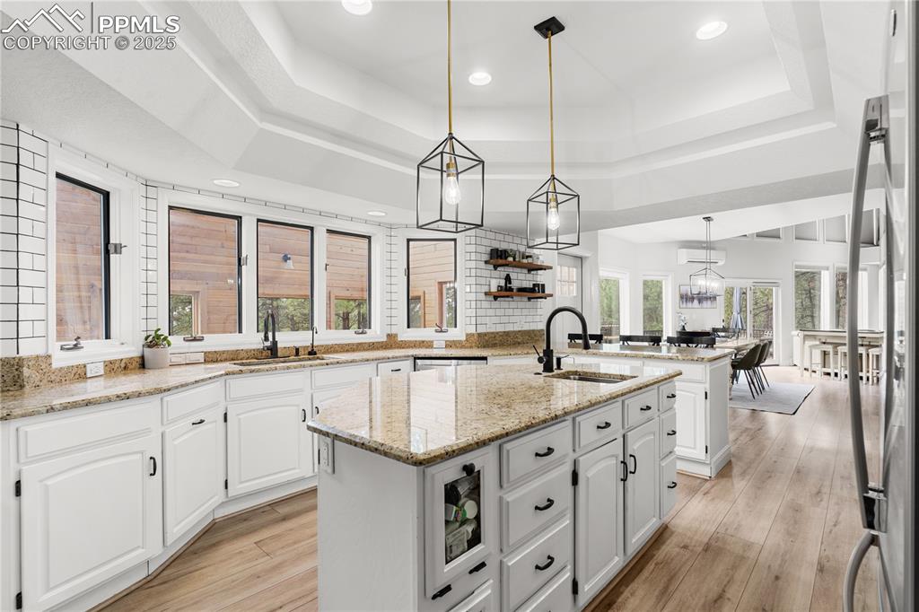 A modern kitchen with anple storage , gleaming subway tile and everything you could need. 