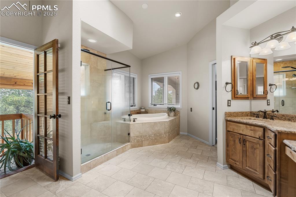 The primary en-suite overlooks the sunroom, with a large soaking tub, dual sinks and large shower. 