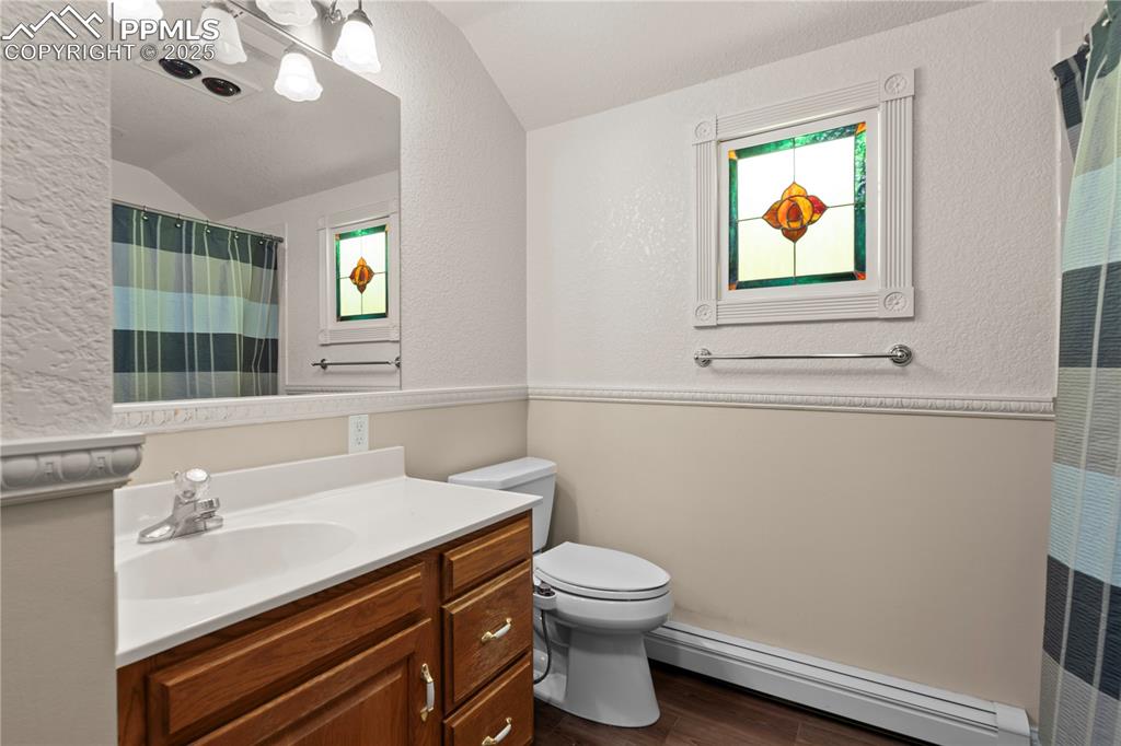 Well lit bathroom with stone counters