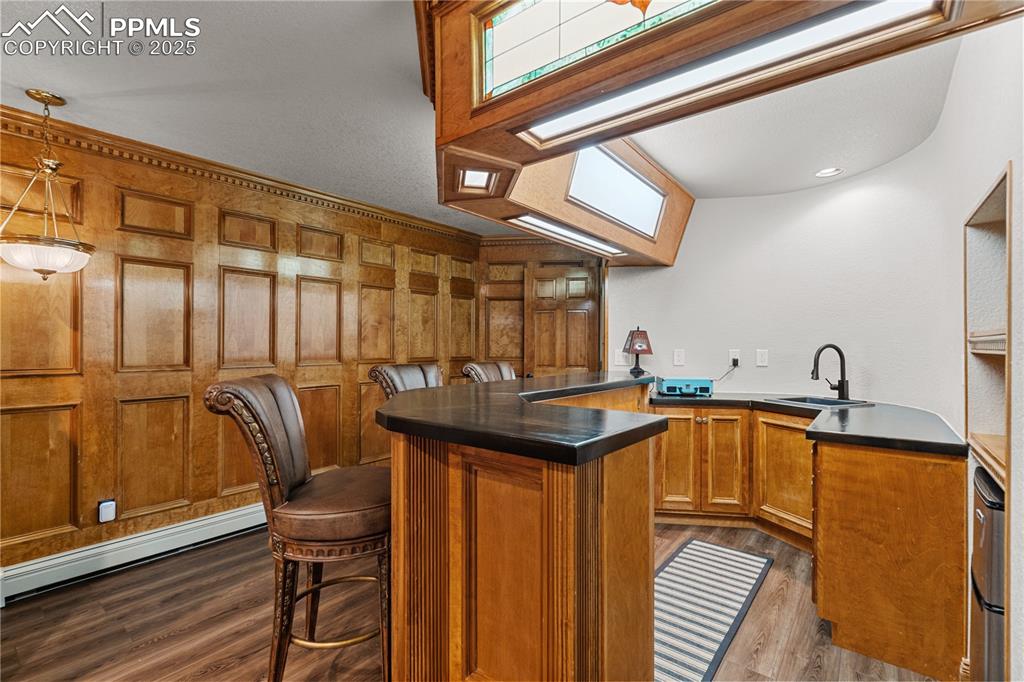 Custom basement bar with sink and beverage cooler