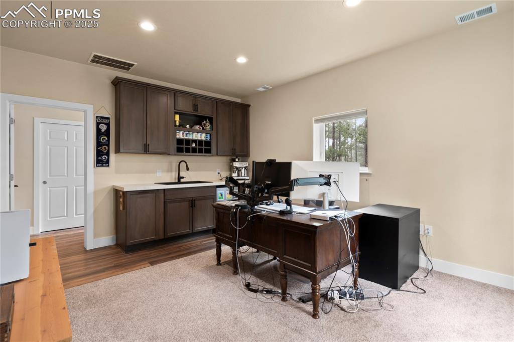 This flex room in the detached garage can be used for many things - has a kitchenette space and attached bathroom.