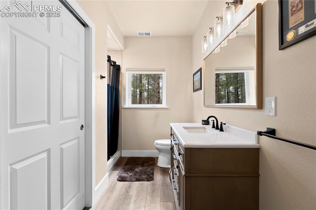 Bathroom with stone counters and closet space in detached garage