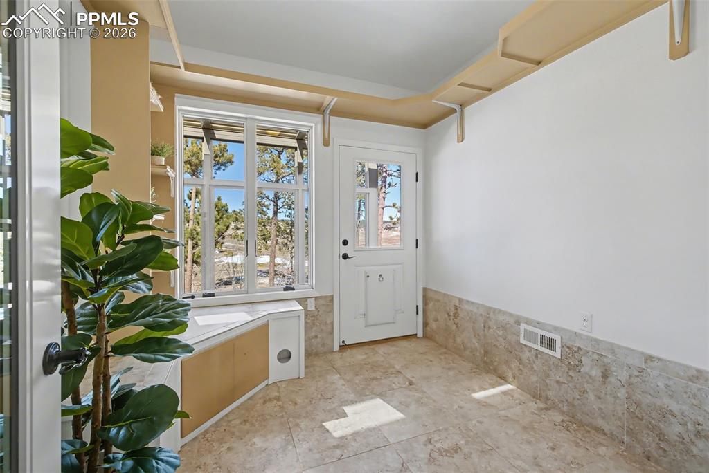 Pet or plant room off the great room. Perfect for transitioning pets from outside to in or for a barn cat to have an indoor safe haven