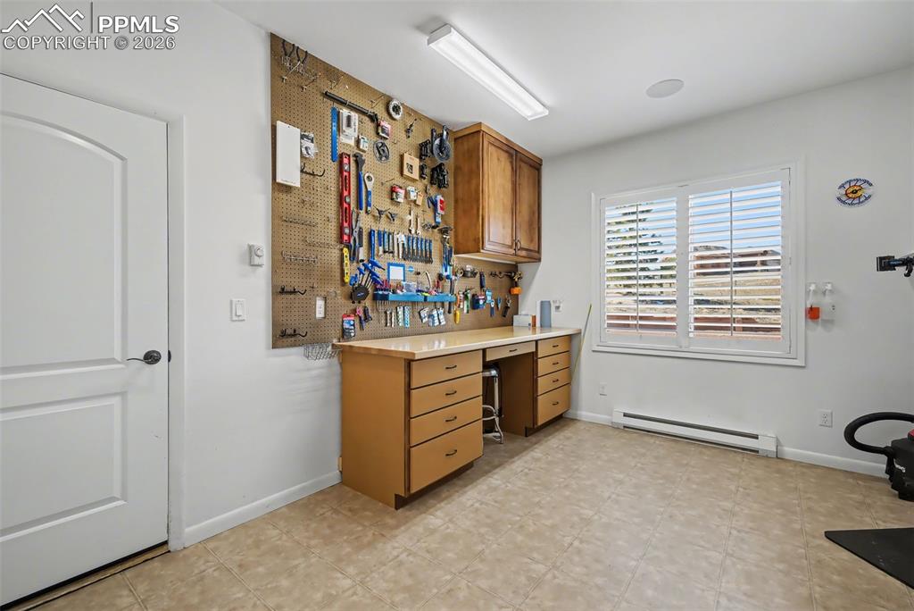 Heated workshop off of the garage to include sink and cabinetry