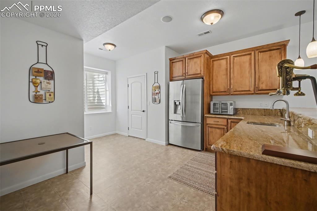 Basement kitchen/wet bar with entrance to the wine cellar.
