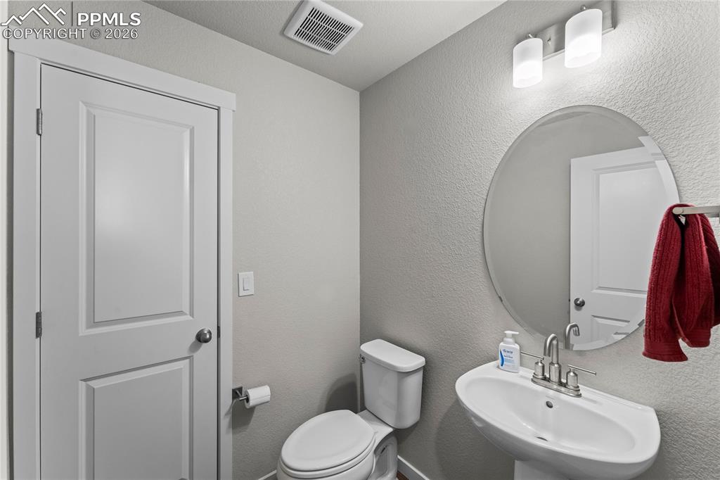 1/2 bath right outside office and entry way on main floor