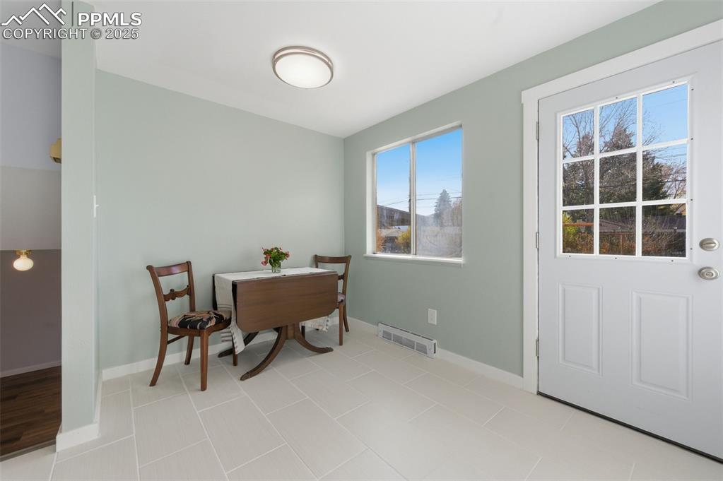 Dining room featuring baseboards and light tile patterned floors