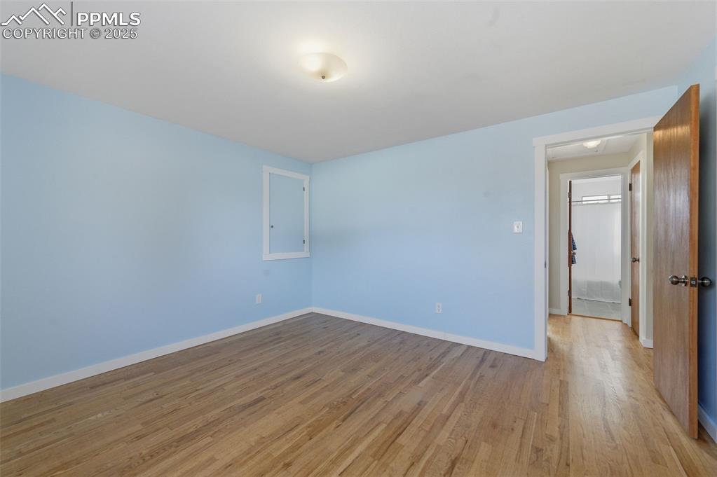 Empty room featuring wood finished floors and baseboards