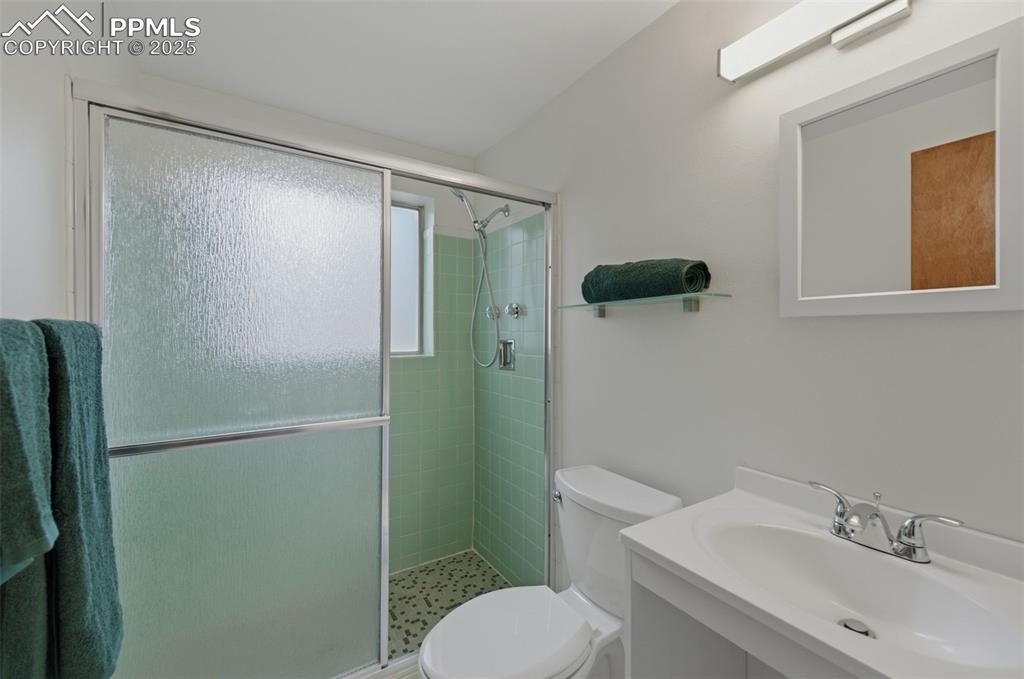 Full bathroom with vanity and a stall shower