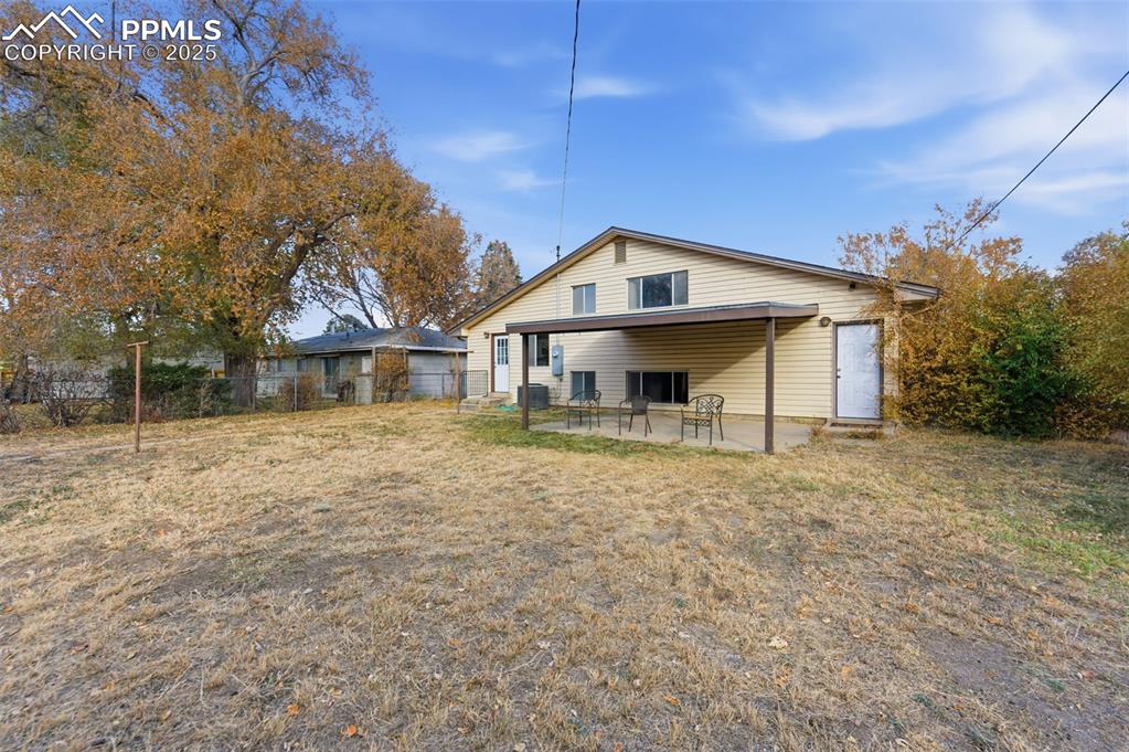 Rear view of property with a patio area and a garage
