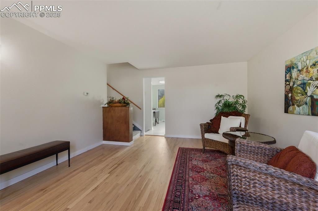 Living area with light wood finished floors and baseboards