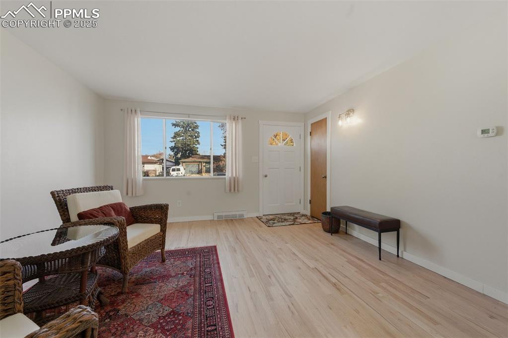 Living room with light wood finished floors and baseboards